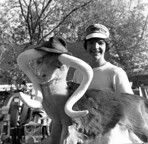 A smiling person posing with a large, unusual garage sale find during the early 1980s.